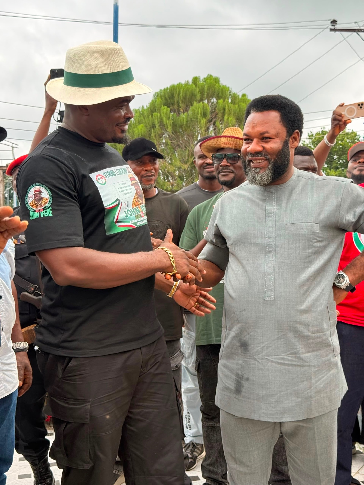 John Ifere shaking hands with a supporter