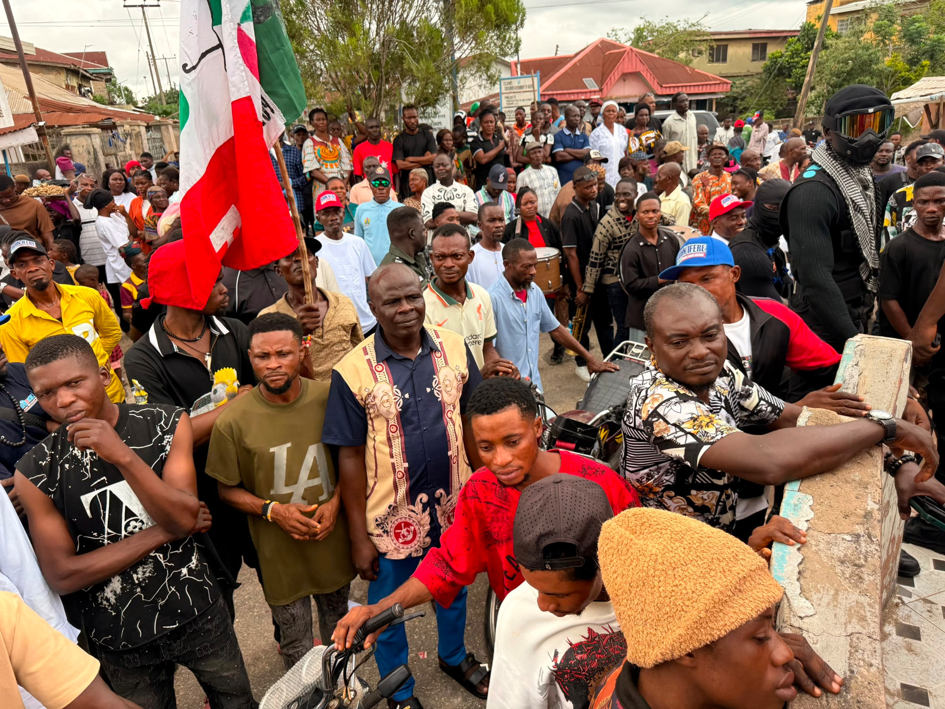 John Ifere with a large crowd holding a PDP flag